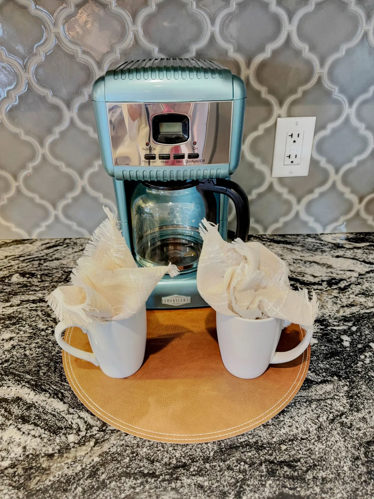 A close-up of a coffee maker with two mugs neatly set out, ready for a shared morning ritual. The setup exudes a sense of calm and togetherness, ideal for starting the day peacefully.